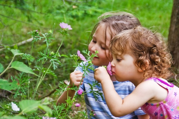 girls_smelling_flowers